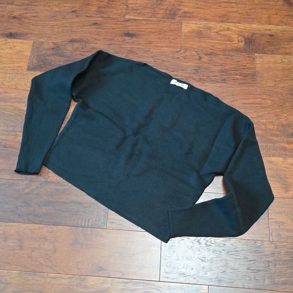 Black ribbed knit boxy pullover sweater with long sleeves and a wide neckline